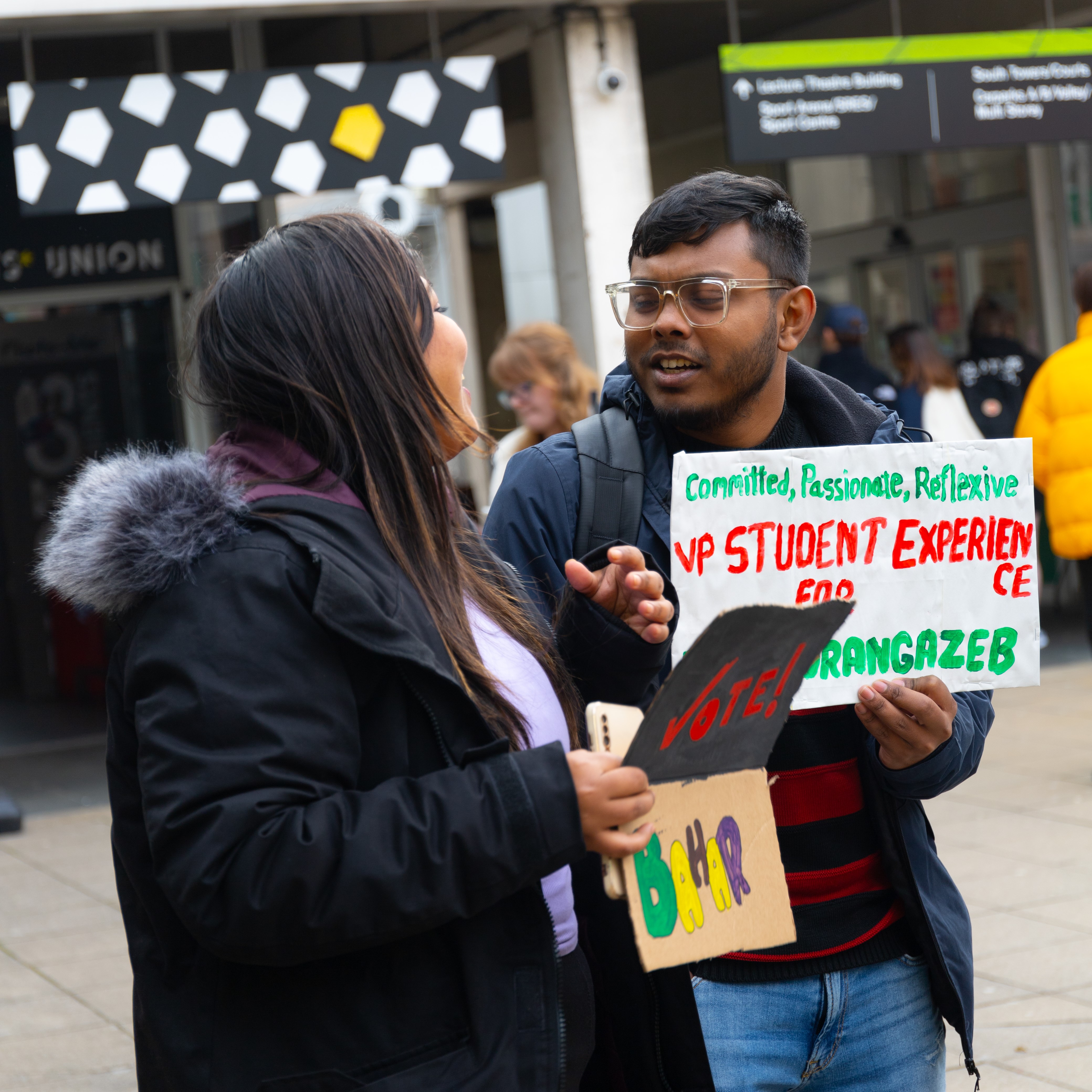 Two Essex students with campaign signs