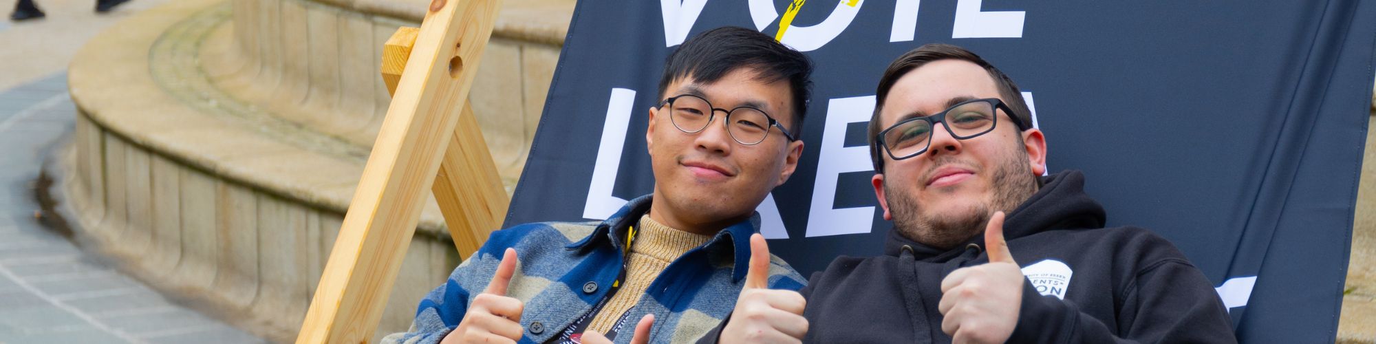 essex students with their thumbs up